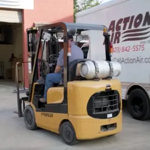 Action Air Technician operating a forklift
