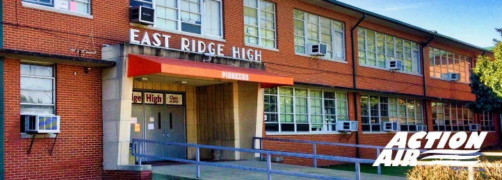 Entrance of East Ridge High School building with brick exterior and red awning over the main doors.