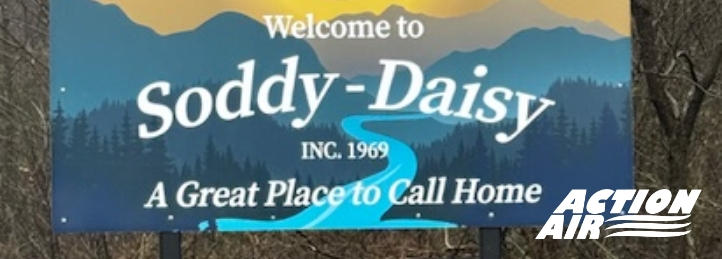 Welcome sign for Soddy-Daisy with scenic mountains and 